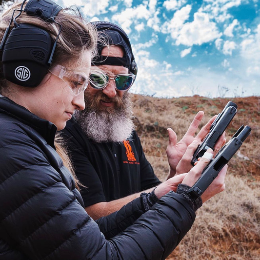 SDR Instructor showing a student how to safely manipulate a pistol