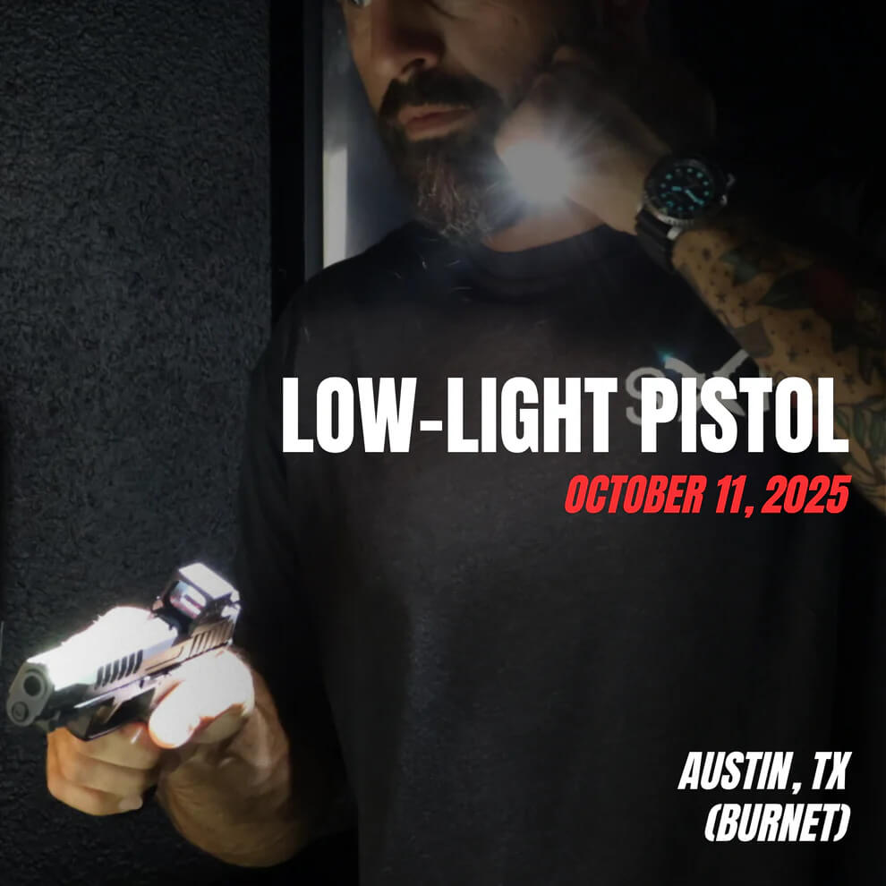 Low-Light Pistol training course in Austin, TX on October 11, 2025. Student practices flashlight and pistol handling techniques in a dark environment for real-world defensive scenarios.