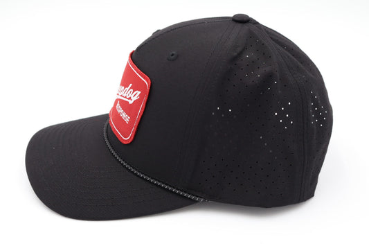 Side view of breathable black Sheepdog Lite Patch Hat showing laser-perforated performance panels and snapback closure